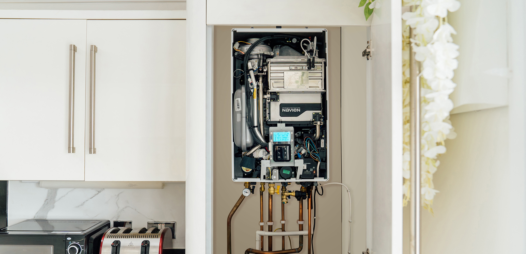 Navien boiler in a kitchen cupboard