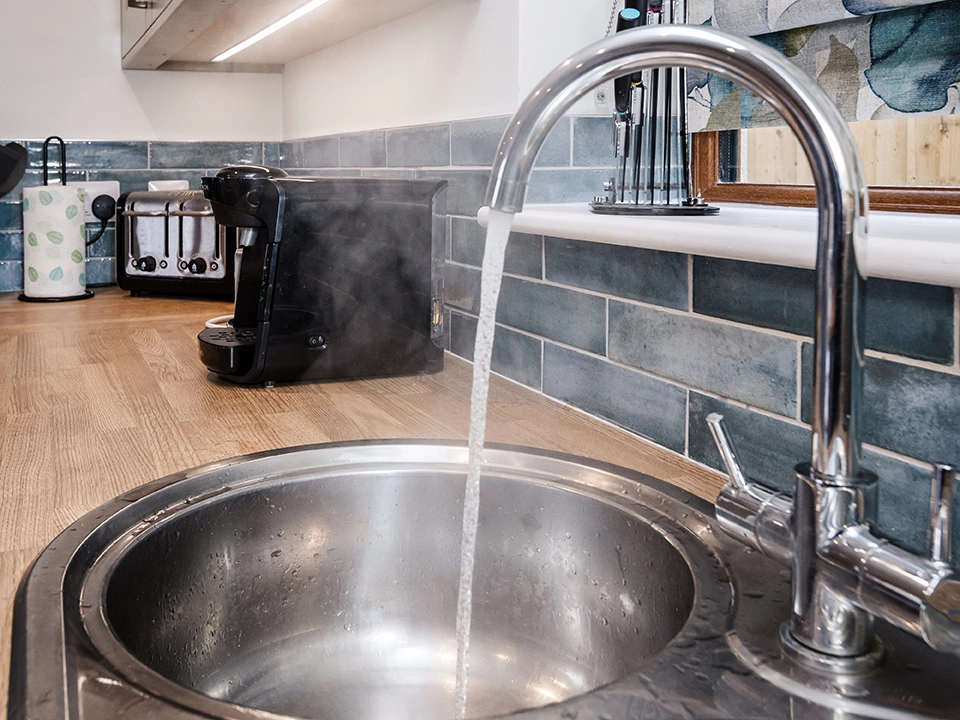 Hot water running through a sink in a kitchen due to navien boiler heating